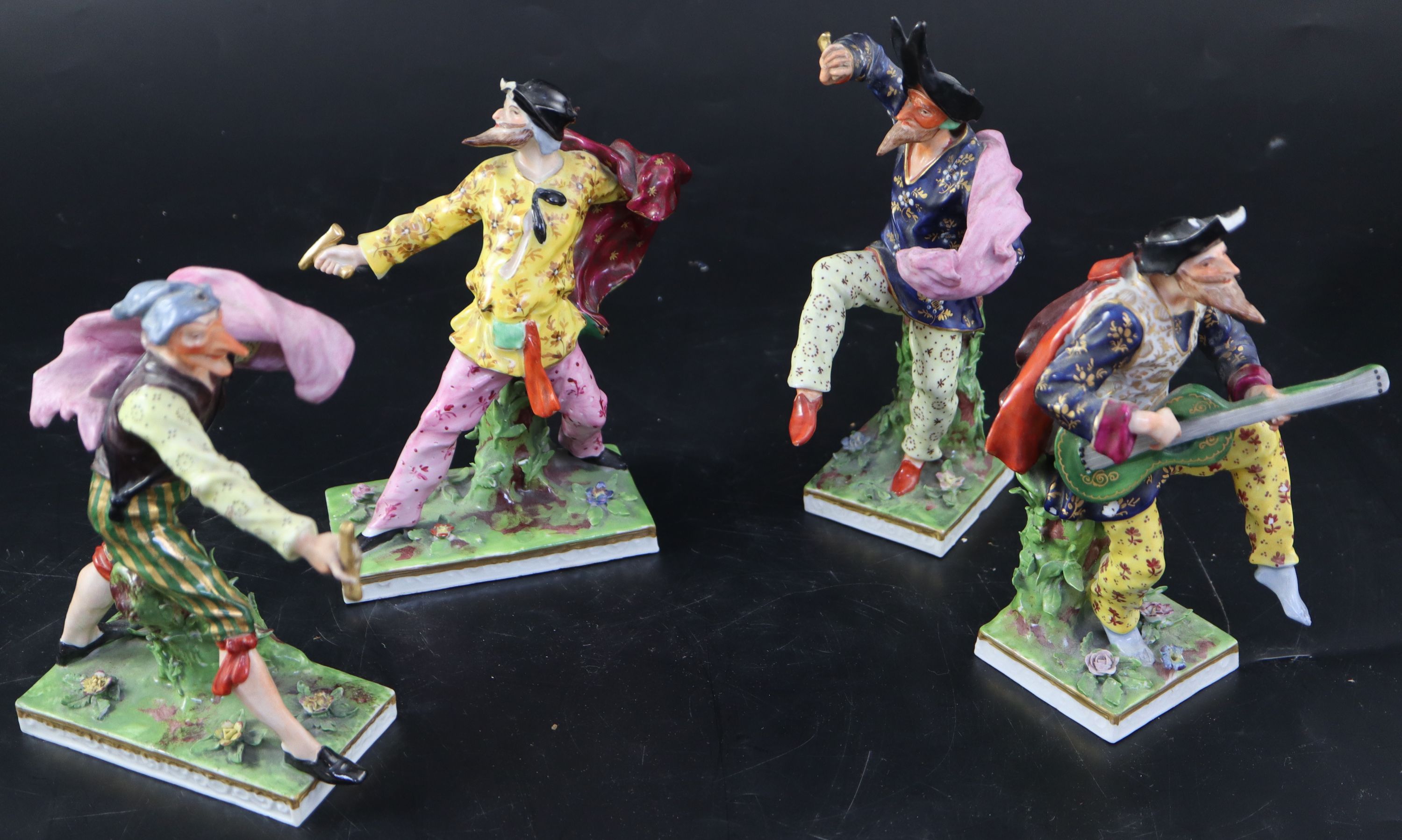 A set of four Continental porcelain Derby-style Comedia del Arte figures, largest 18.5cm